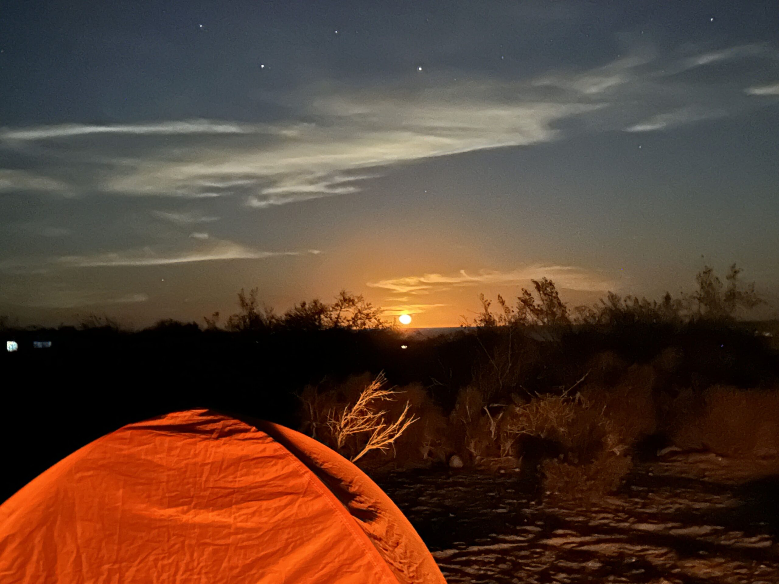 Tent and campfire at a remote camping spot